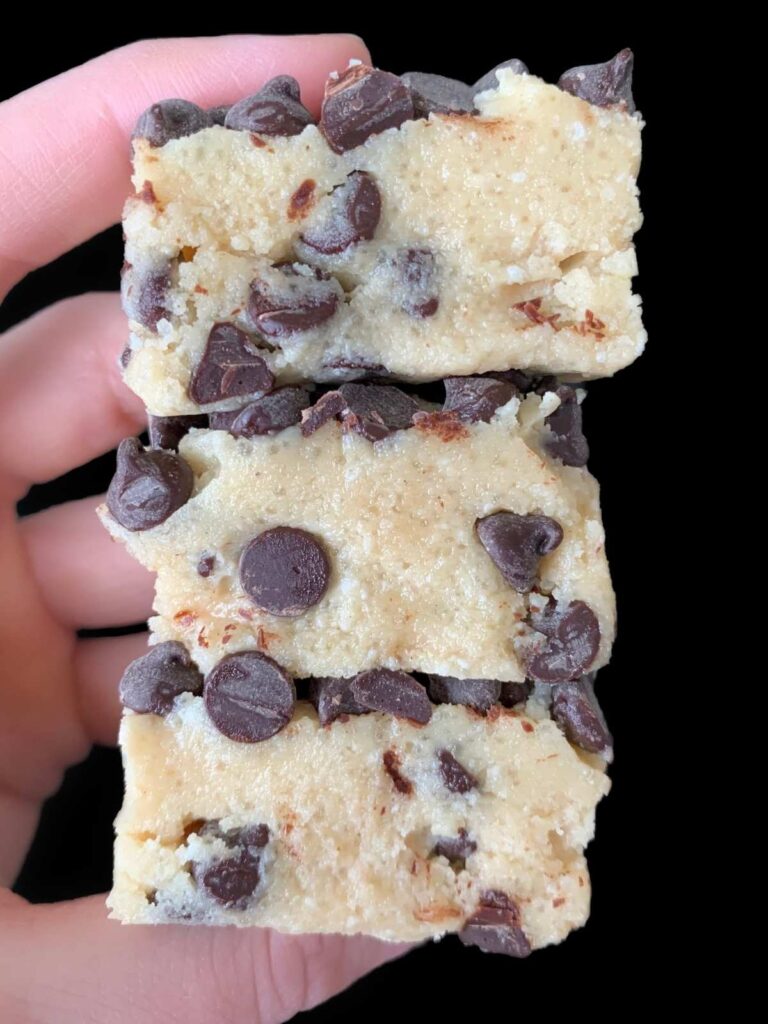 hand holding a stack of keto cookie dough bars