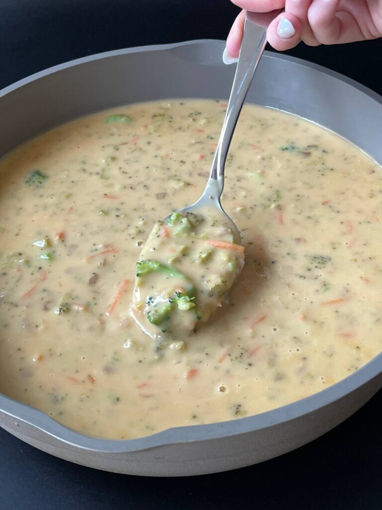 spoonful of keto broccoli cheddar soup in the pan