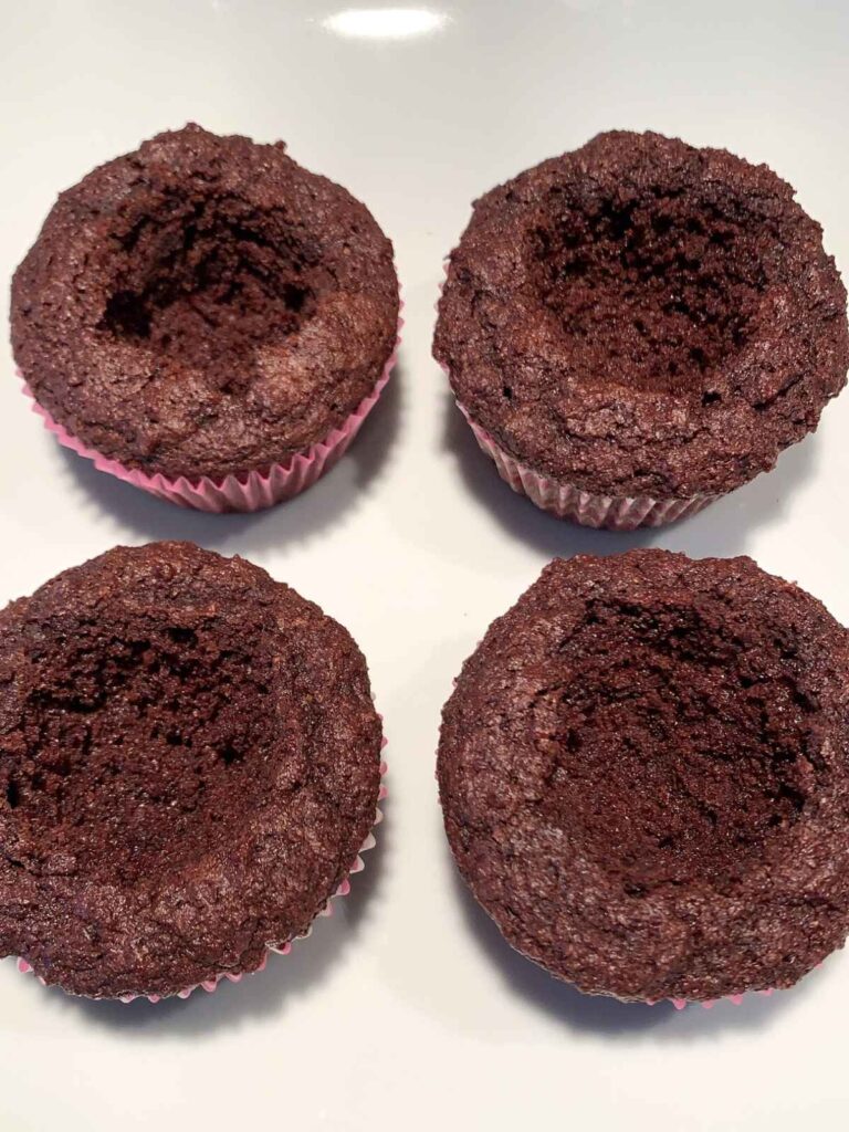 chocolate cupcakes with holes cut out in the center