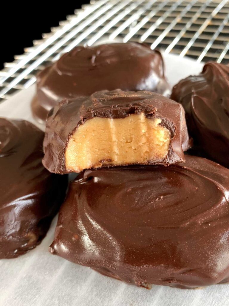 keto peanut butter eggs, one has a bite taken out of it