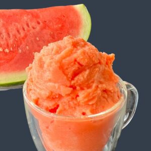 hydrating watermelon sorbet in a cup with a watermelon slice in the background