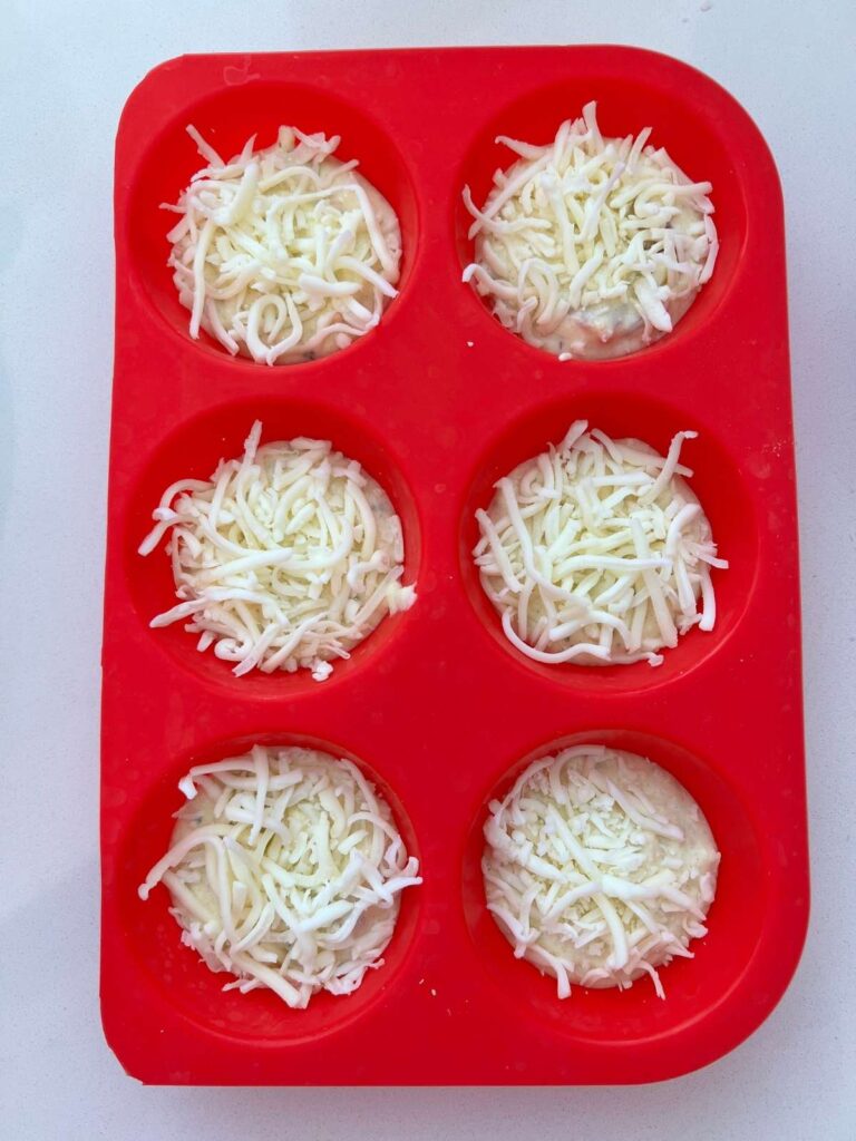 cheese added to each muffin cup
