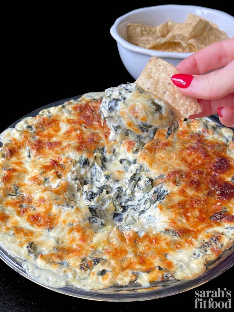 high protein spinach artichoke dip served with tortilla chips